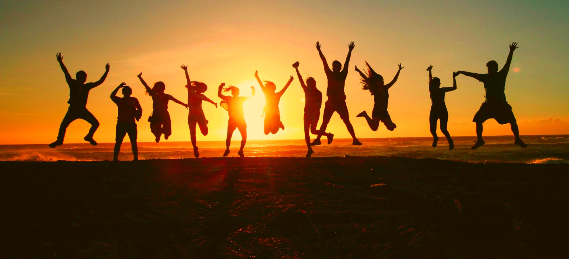 A group of people celebrating together at sunset